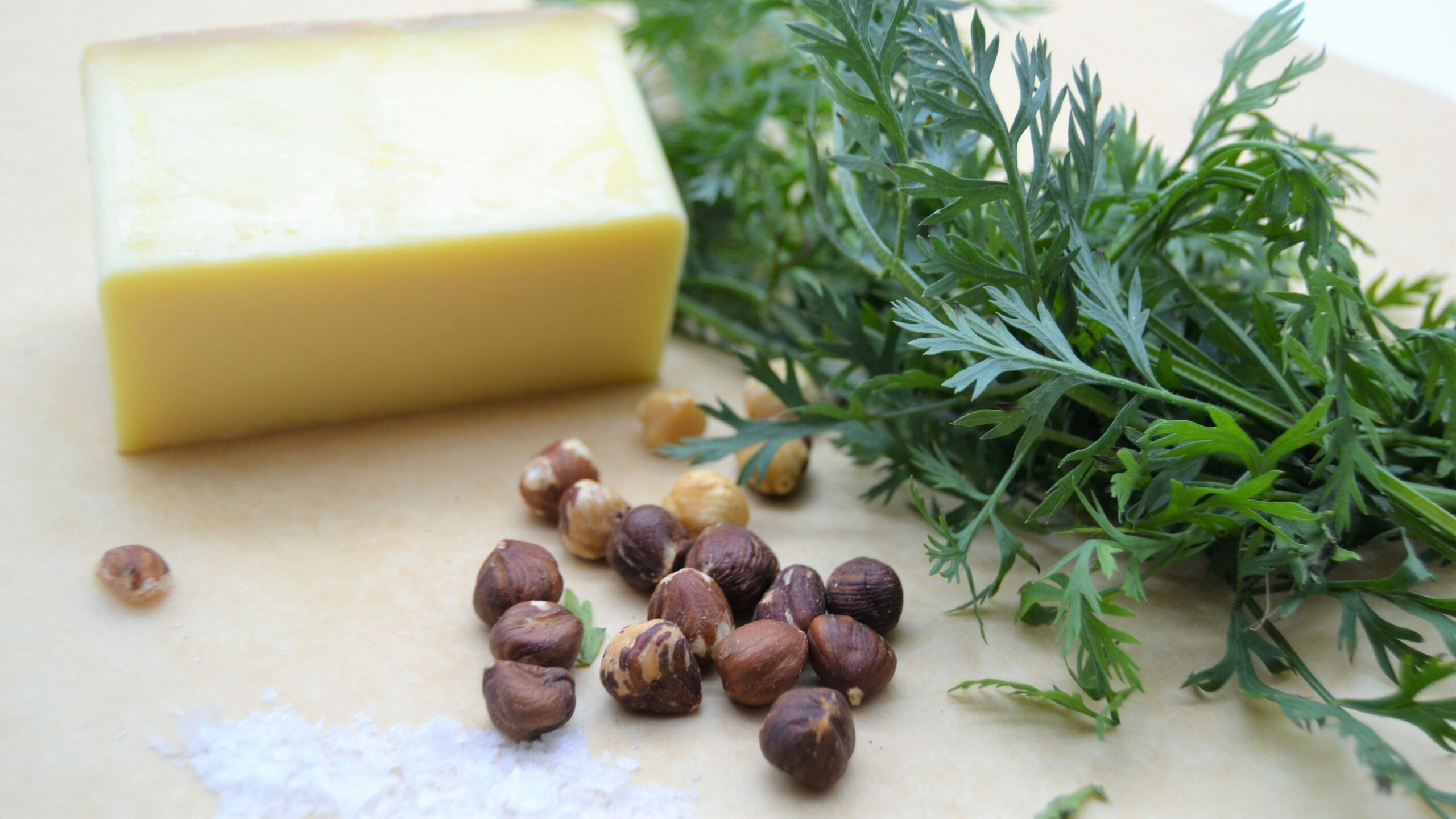 Ingredients layflat composition with shea butter nuts essential oils and chelidoine plant on wooden table